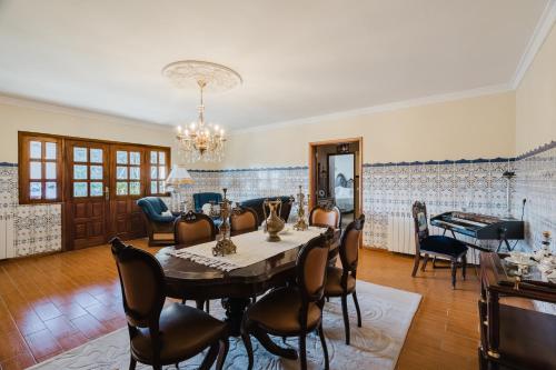 a dining room with a table and chairs at Quinta do Passal - Gondoriz in Arcos de Valdevez