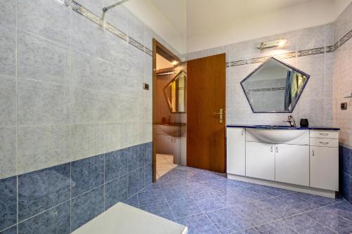 a bathroom with a shower and a sink and a mirror at Casa Valentina in Ledro