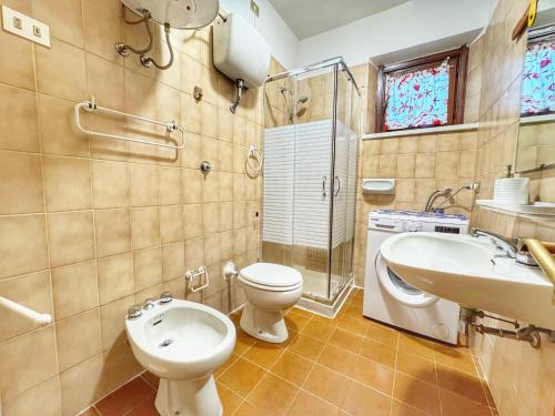 a bathroom with a toilet and a sink at Casa 3 Punta Negra in Stintino