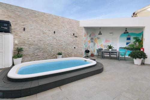 a large swimming pool in a yard with a patio at Casa Mourato - Smart and Eco Wonder in São Domingos de Rana