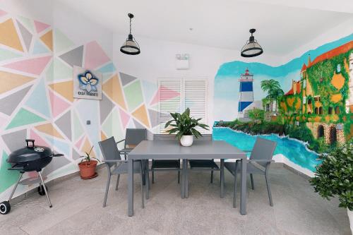 a dining room with a table and a mural at Casa Mourato - Smart and Eco Wonder in São Domingos de Rana