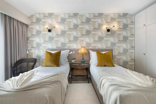 two twin beds in a room with a wall at Casa Mourato - Smart and Eco Wonder in São Domingos de Rana