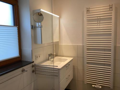 a bathroom with a sink and a mirror at Casa Rural in Nerenstetten