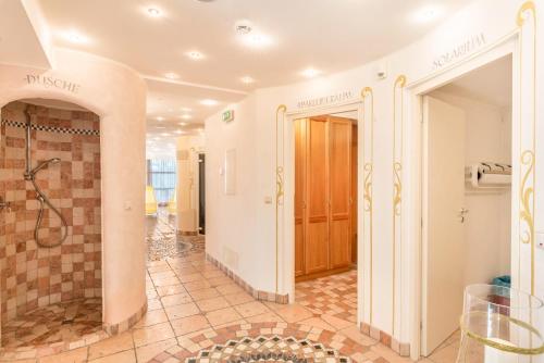 a bathroom with a shower and a tile floor at Residence Diana Apartment 101 in Terento