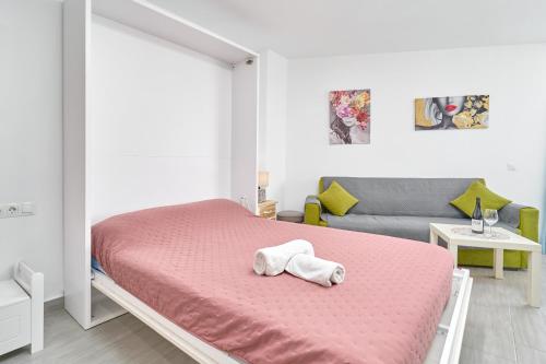 a bedroom with a bed with a stuffed animal on it at Estudio El Faro 2 in Torrox