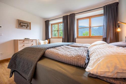 a bedroom with two beds and a window at Valentin36 Apartment Raschötz in Funes
