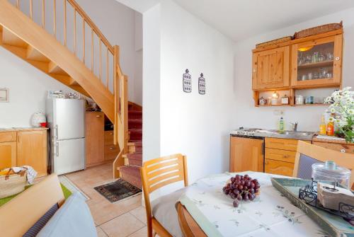 a kitchen with a dining table and a staircase at Gästehaus Knuth Zinnowitz in Zinnowitz