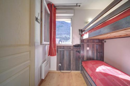a bedroom with a bunk bed and a window at A 208 Pics D'aran in Luchon