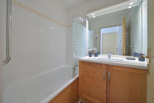 a bathroom with a sink and a shower and a tub at A 208 Pics D'aran in Luchon