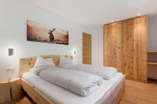 a bedroom with two beds with white sheets at Prielerhof in San Lorenzo di Sebato