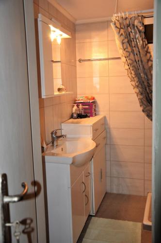 a bathroom with a sink and a mirror at House For Rent In Apostolous in Apóstoloi
