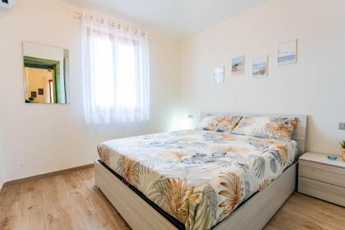 a bedroom with a large bed in a room at Dimora Frau in Villasimius