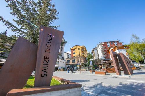 a sign with the word tourism on a city street at Studio Clotes Ski In - Ski Out - Happy Rentals in Sauze dʼOulx