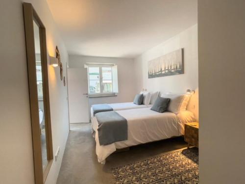 a bedroom with a large bed and a window at Jasmine House in Tavira