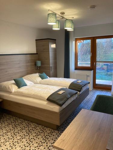 a bedroom with a large bed with a wooden headboard at Casa Rural in Nerenstetten
