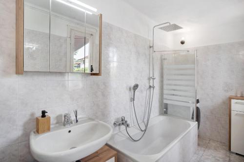 a white bathroom with a sink and a shower at Casa Leah in Imperia