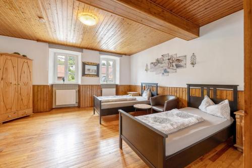 a living room with a bed and a couch at Restaurant Fewo Golsong in Thaleischweiler-Fröschen