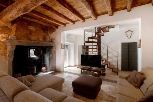 a living room with a couch and a fireplace at Thari House Como Lake in Naggio