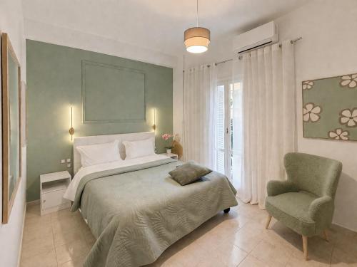 a bedroom with a large bed and a chair at Wake in the Lake III in Agios Nikolaos