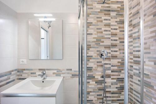 a bathroom with a sink and a shower at Domus Madonnina in Sanremo