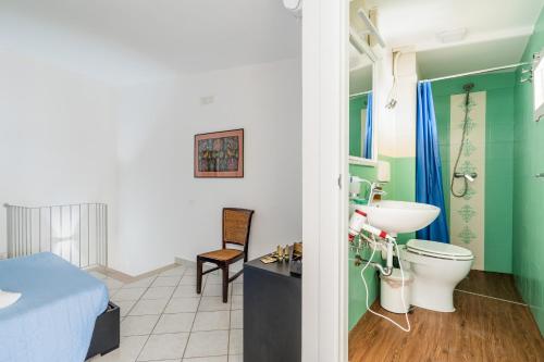 a bathroom with a toilet and a sink at Civico4 luxuryholidays in Casarano