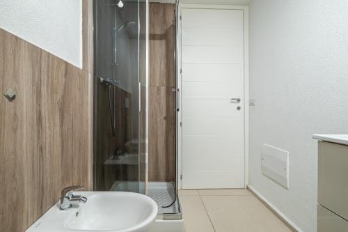 a bathroom with a sink and a glass shower at Cormorani appartamento N 5 in Golfo Aranci