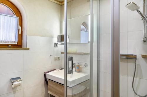 a bathroom with a sink and a shower at Haus Verena Mittenwald in Mittenwald