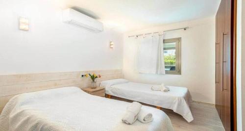 a room with two beds and a window at Francisca in Pollença