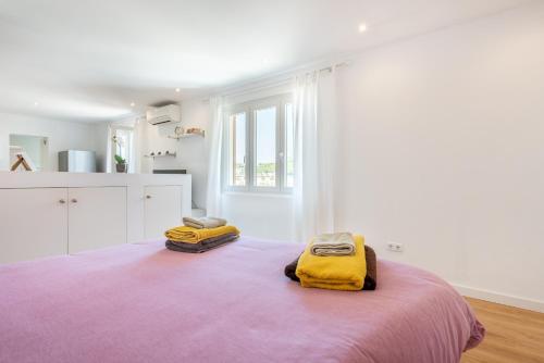 a bedroom with a large bed with yellow blankets at The Olives in Port de Soller