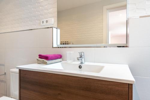 a bathroom with a sink and a mirror at The Olives in Port de Soller