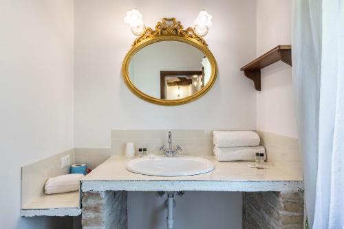 a bathroom with a sink and a mirror at Tenuta Ca' Zen - Cottage Casetta in Taglio di Po