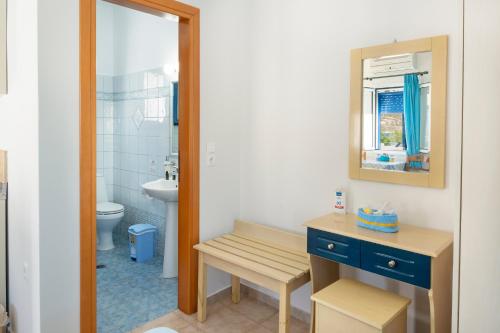 a bathroom with a sink and a toilet and a mirror at Studios Ninemia Serifos 5 in Livadi