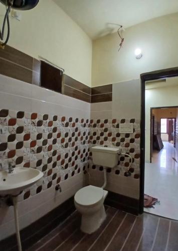 a bathroom with a toilet and a sink at Agam Homestay - Few Steps From golden temple in Amritsar