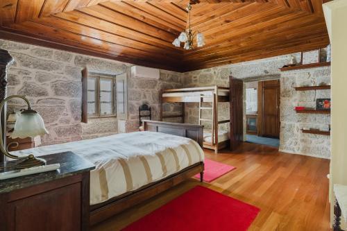 a bedroom with a bed and a wooden ceiling at Cantinho da Tilde in Fafe