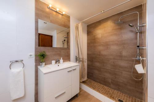 a bathroom with a white sink and a shower at Finca Es Carregador in Capdepera