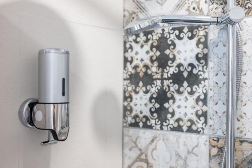 a bathroom with a shower door with aaucet at Sg Apartment Standard Plus in Massafra