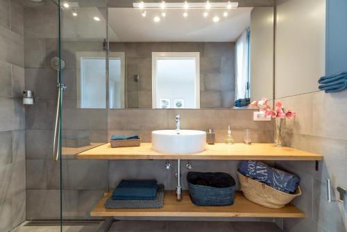 a bathroom with a sink and a shower at Ocean view apartment renovated in Gavà