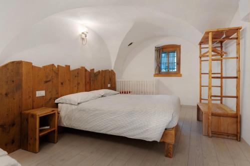 a bedroom with a bed and a ladder in it at Logge dei Paroloti Agnese in San Lorenzo in Banale