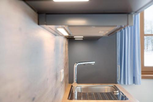 a bathroom with a sink and a window at Ferienwohnung Alpenveilchen in Grainau