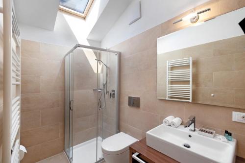 a bathroom with a shower and a sink and a toilet at Kriendl Nr 4 in Valdaora