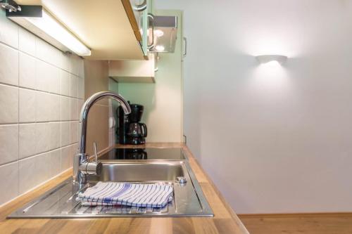 a kitchen sink with a towel on the counter at Sabina Dolomites Puflatsch in Alpe di Siusi