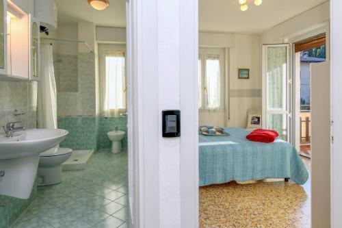 a bedroom with a bed and a bathroom with a sink at Liver 201 in Tremosine Sul Garda