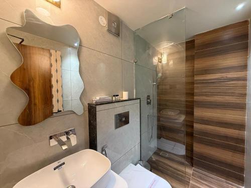 a bathroom with a toilet and a sink and a shower at Hotel Kama, Patna in Patna