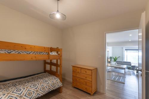 a bedroom with a bunk bed and a desk at Gîte les Monteils in Vesseaux