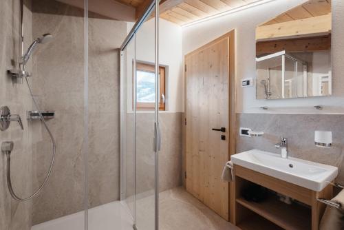 a bathroom with a shower and a sink at Ciasa Willy App Conturines in La Villa