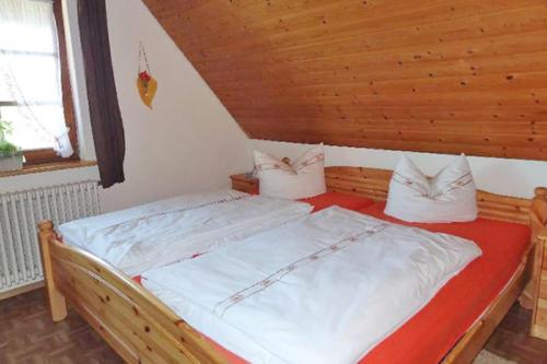 a bedroom with a bed in a wooden room at Schlossberghof Schnellingen in Haslach im Kinzigtal