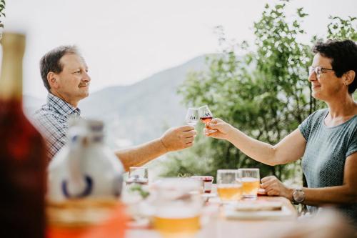 a group of people sitting around a table drinking wine at Schlossberghof Schnellingen in Haslach im Kinzigtal