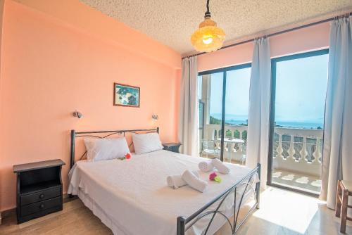 a bedroom with a bed and a large window at Andromaches apartment sea view 2 in Corfu