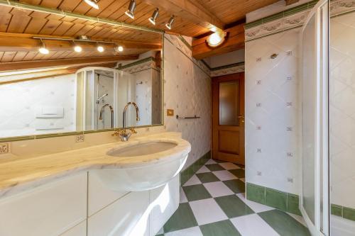 a bathroom with a sink and a mirror at Ciasa Sommavilla Mansarda in Vigo di Fassa