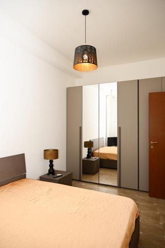 a bedroom with a bed and a mirror at La casetta di Claudia in Nettuno